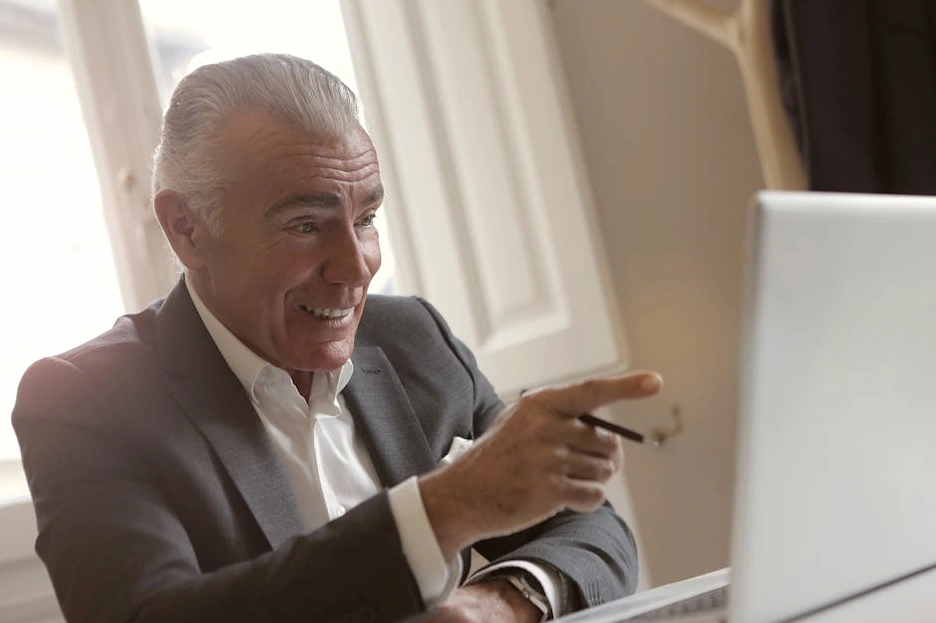 A business consultant smiling during a video call.